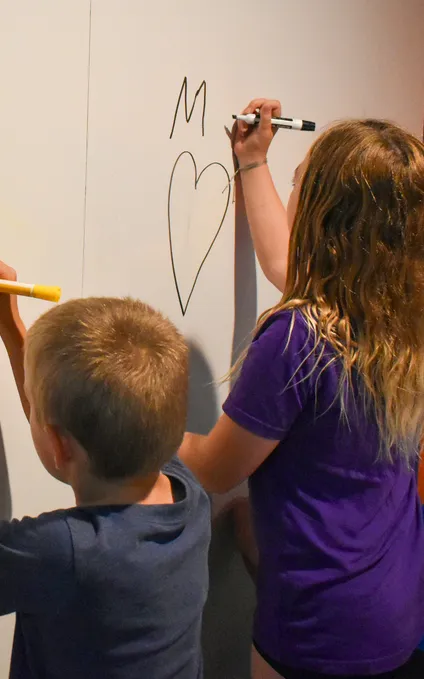 Children completing homework and playing games in after school program