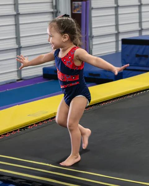 Happy toddlers exploring colorful gymnastics equipment in safe, age-appropriate setting